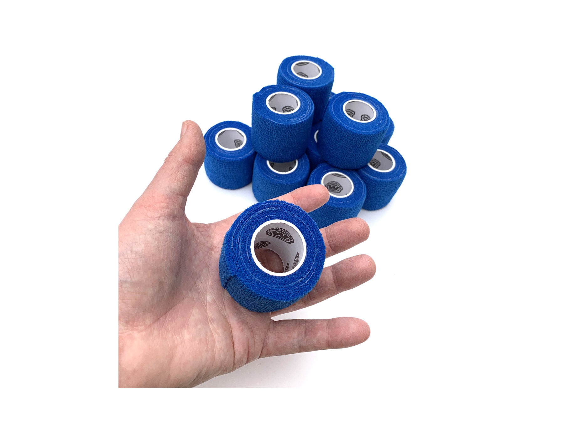 Hand Holding 1 of 12 rolls of Blue WildCow 2 Inch Vet Wrap