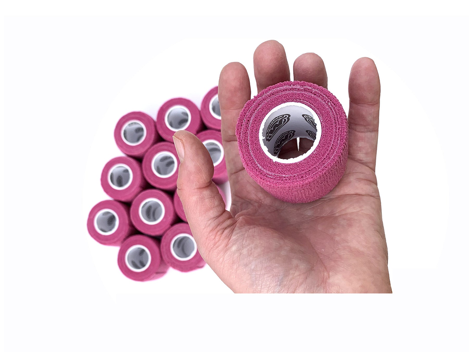Hand Holding 1 of 12 Rolls of WildCow Pink 2 Inch Vet Wrap