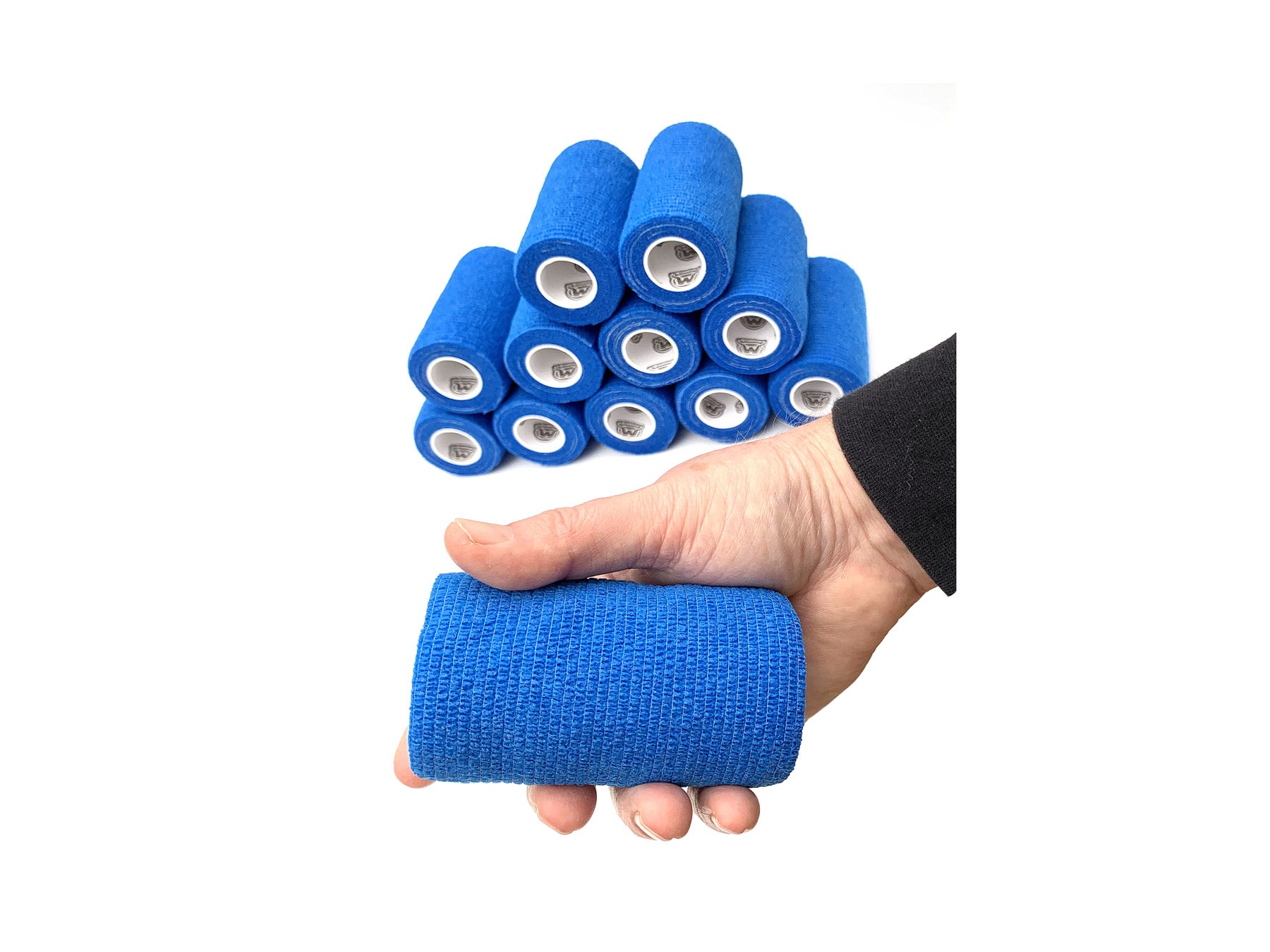Hand Holding 1 of 12 Rolls of WildCow Blue 4" Vet Wrap