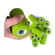 Hand holding 1 of 12 rolls of WildCow 4 Inch Grass Green Vet Wrap