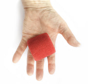 Hand Holding One Roll of WildCow 2 Inch Red Vet Wrap